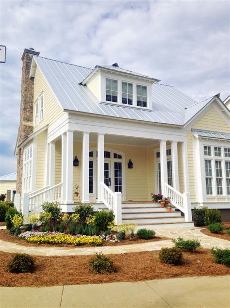 red metal roof yellow house|yellow house with gray roof.